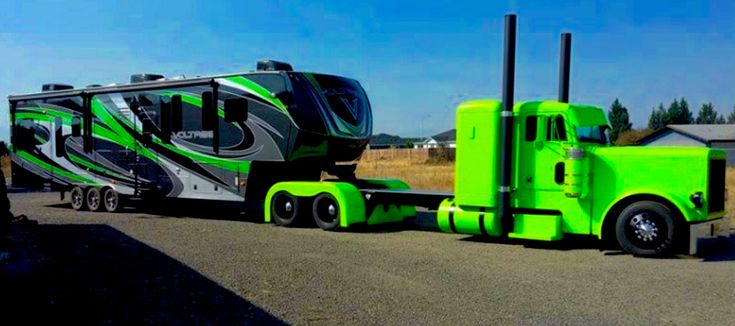 a green truck with a trailer attached to it