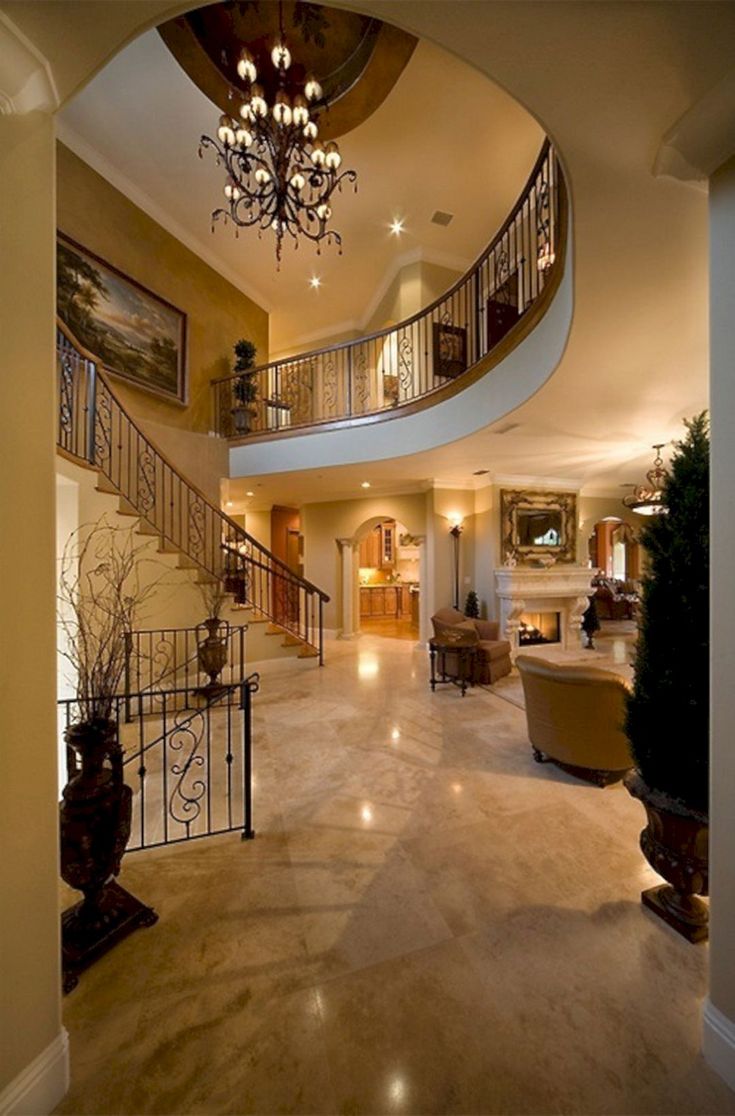 a large foyer with chandelier and stairs leading up to the second floor area