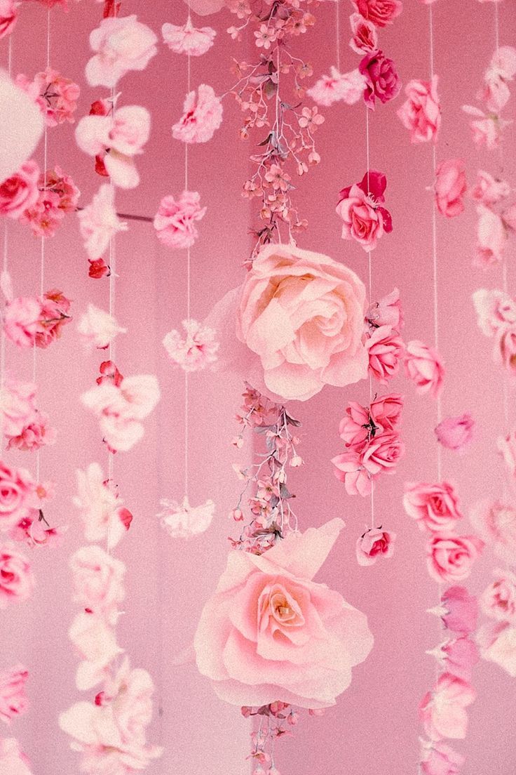 pink and white flowers hanging from the ceiling