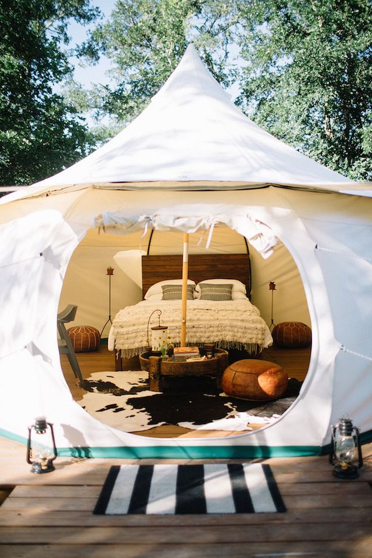 the inside of a tent with a bed in it