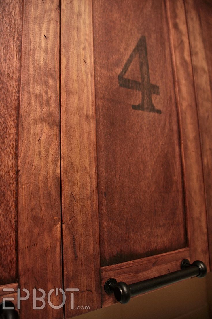 the number four is etched into the wooden cabinet doors