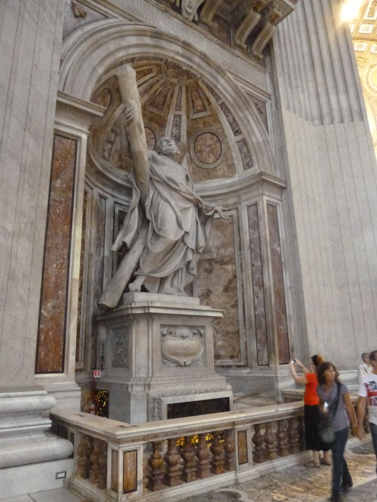 people are standing in front of a statue