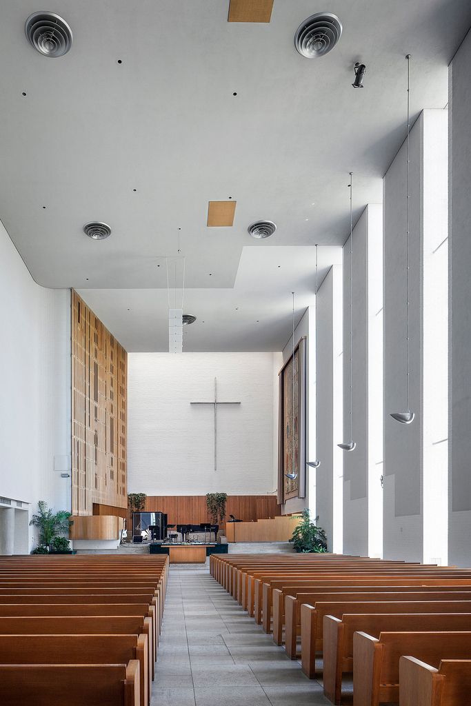 an empty church with wooden pews and windows