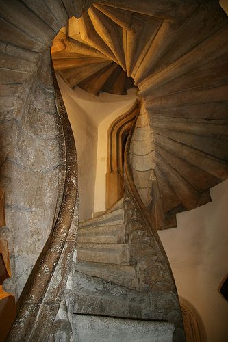 a spiral staircase in an old stone building