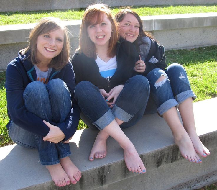 three young women sitting on the steps outside