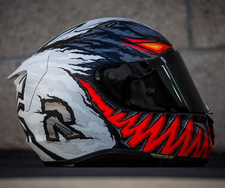 the helmet is painted with red and black designs