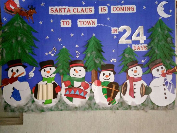 a bulletin board with snowmen and christmas trees