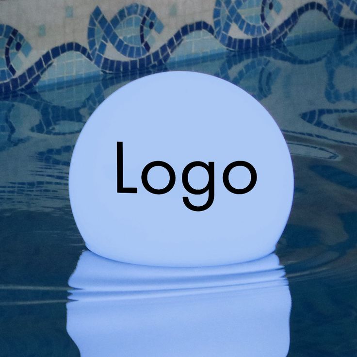 a white ball with the word logo on it floating in water next to a tiled wall