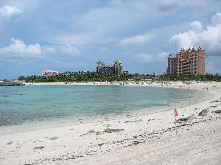 the beach is clear and blue with people on it