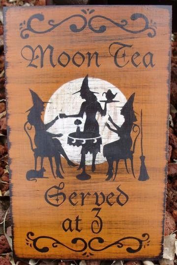 a wooden sign with the words moon tea on it and witches silhouettes in front of a full moon