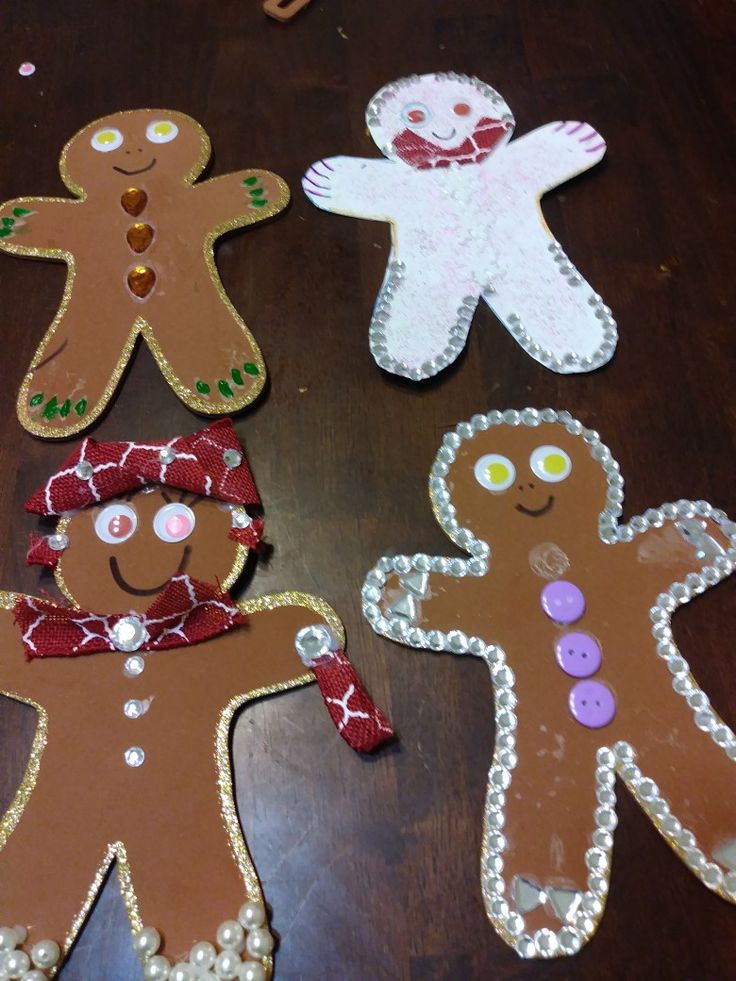 three gingerbread cut outs are sitting on a table