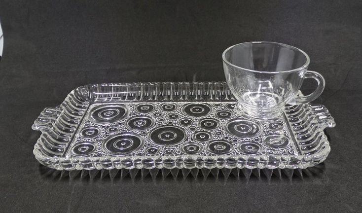 a clear glass tray with a cup on it