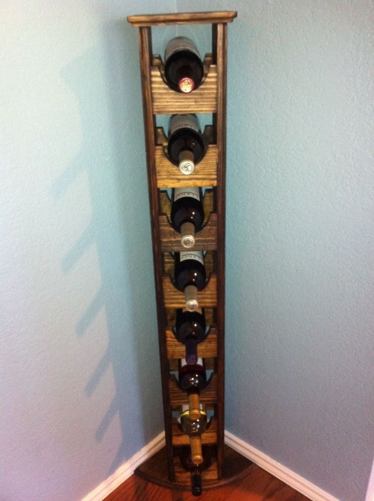 a wooden wine rack with many bottles in it