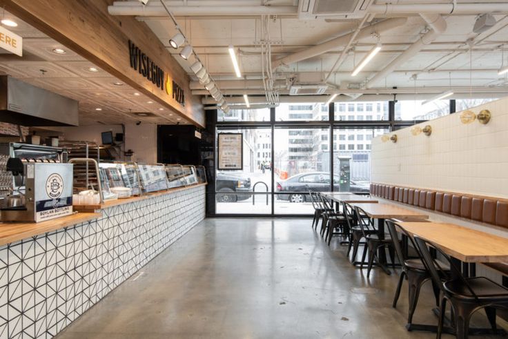 the inside of a restaurant with tables and chairs