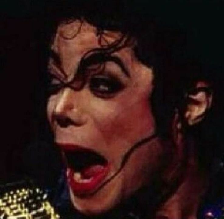 michael jackson singing into a microphone with his mouth open and tongue out in front of him