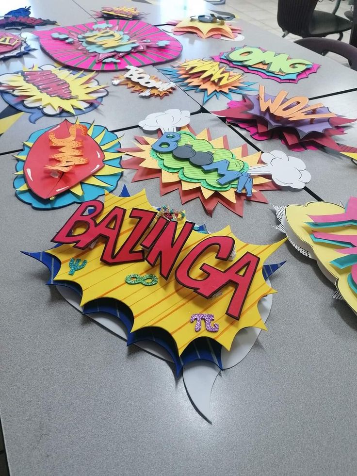 a table topped with lots of cut out signs and paper art pieces on top of it