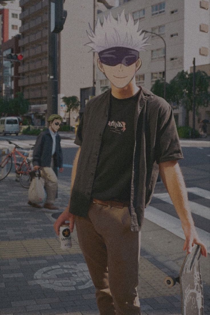 a man holding a skateboard on the sidewalk in front of some buildings and people