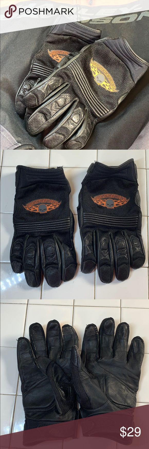 two pairs of black leather gloves sitting on top of a tiled floor next to each other