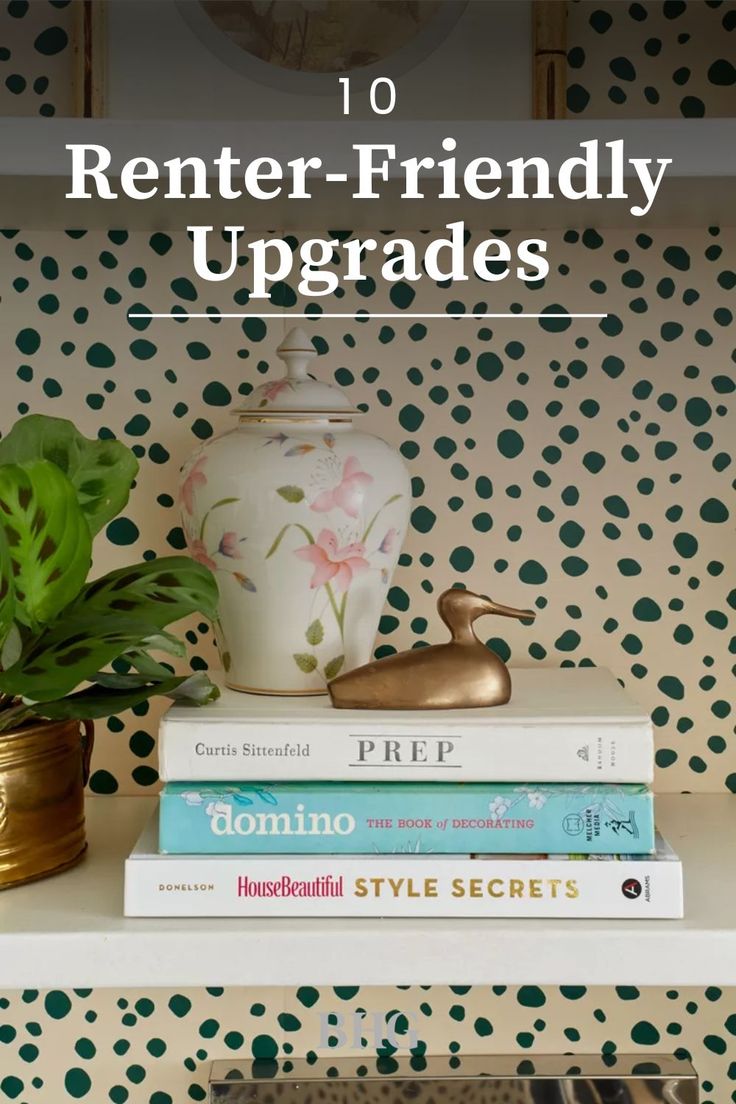 books are stacked on top of each other in front of a polka dot wallpaper