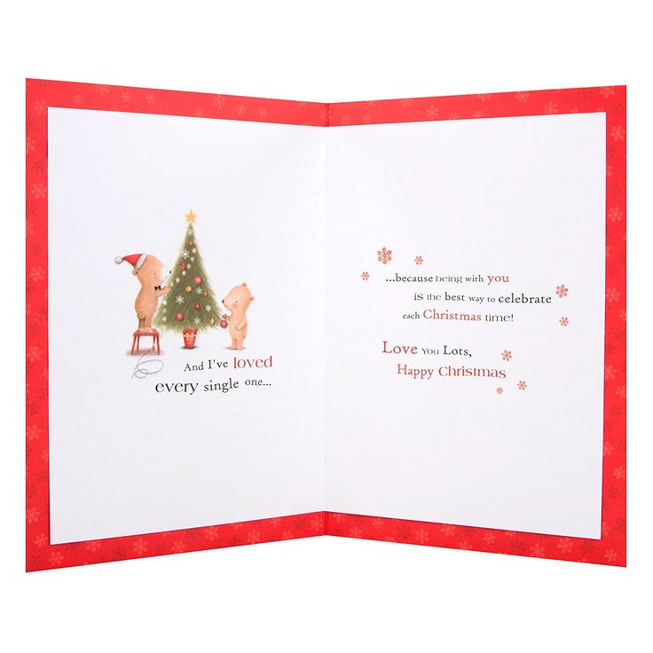 an open christmas card with reindeers and a tree on the front, in red