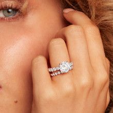 a close up of a person wearing a diamond ring