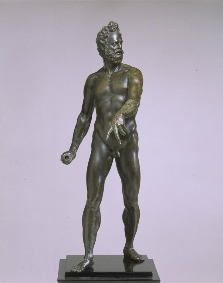 a bronze statue of a man with his hands in his pockets