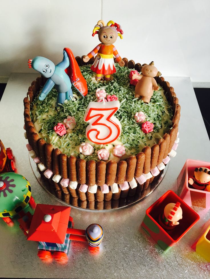 a birthday cake decorated with toys and decorations