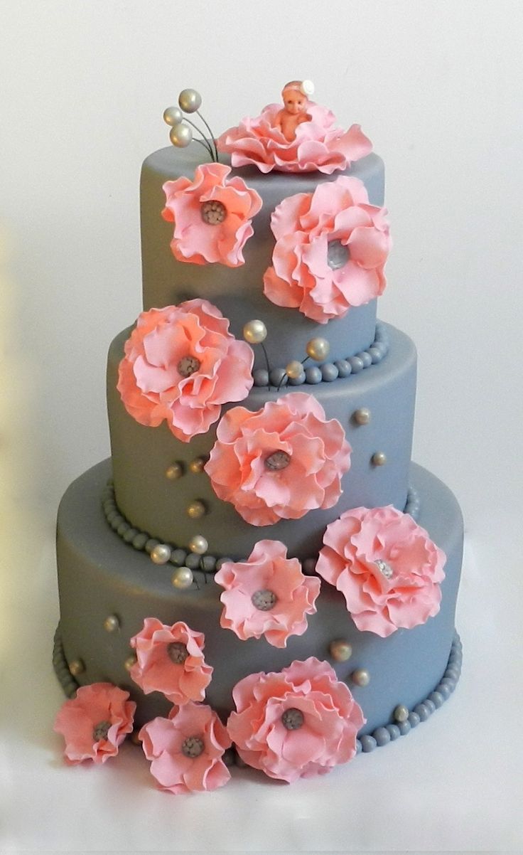 a three tiered cake with pink flowers on it