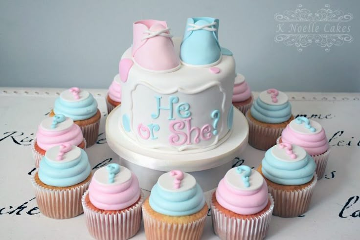 cupcakes are arranged around a cake on a table