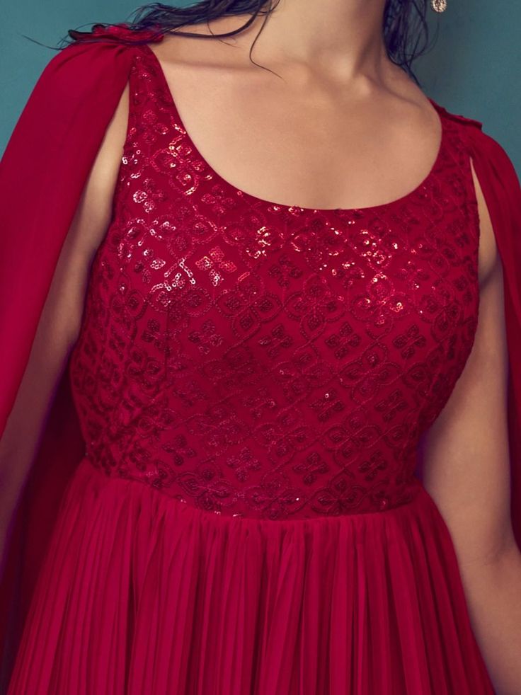 Are you looking for a gown that will elevate your look for a wedding, reception, party, sangeet, or to stand out as a beautiful bridesmaid? Look no further than the Mesmerizing Red Sequins Georgette Ready-Made Bridesmaid Gown, available now from Ethnic Plus. With its stunning red color and intricate sequin work on delicate georgette fabric, this gown is sure to catch the eye of everyone in the room. The attached dupatta adds an extra touch of elegance and sophistication to this already show-stop Sleeveless Bollywood Dresses For Receptions, Bollywood Style Sleeveless Dress For Reception, Red Georgette Lehenga For Evening, Sleeveless Sequined Anarkali Set For Party, Traditional Evening Dress For Wedding, Festive Sleeveless Gown With Dupatta, Sleeveless Party Dress With Dupatta, Sleeveless Semi-stitched Dresses For Reception, Sleeveless Georgette Gown For Wedding