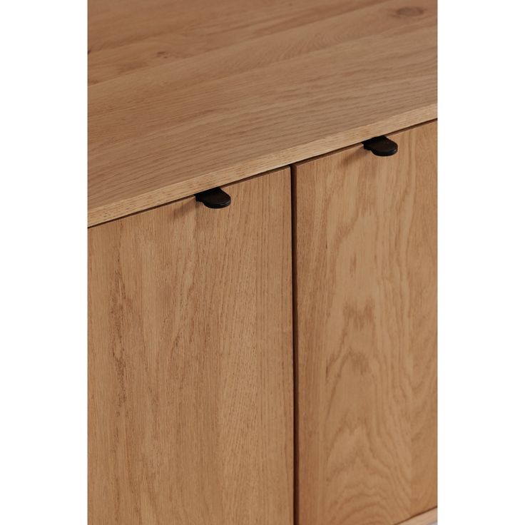 a wooden cabinet with two black handles on it