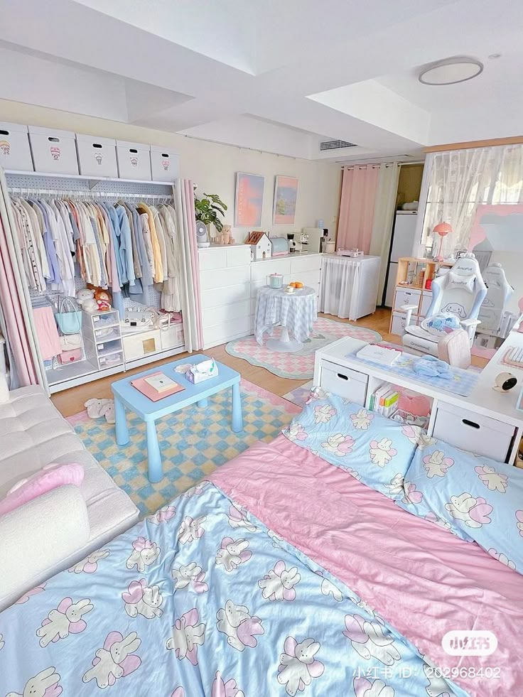 a bedroom with pink and blue bedding, white dressers, and closets