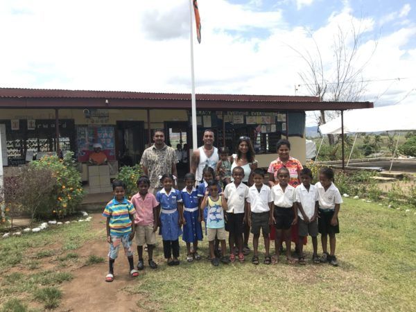 a group of children standing in front of a building