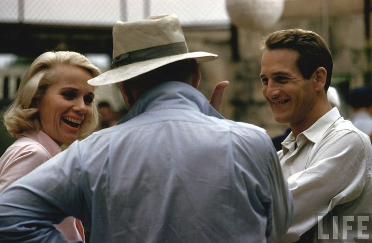 two men and a woman are talking to each other