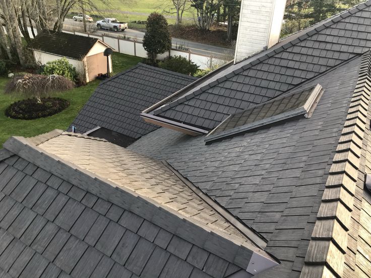 the roof of a house with two dormers and one window on top of it