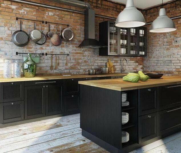 an image of a kitchen setting with black cabinets and wooden counter tops in the middle