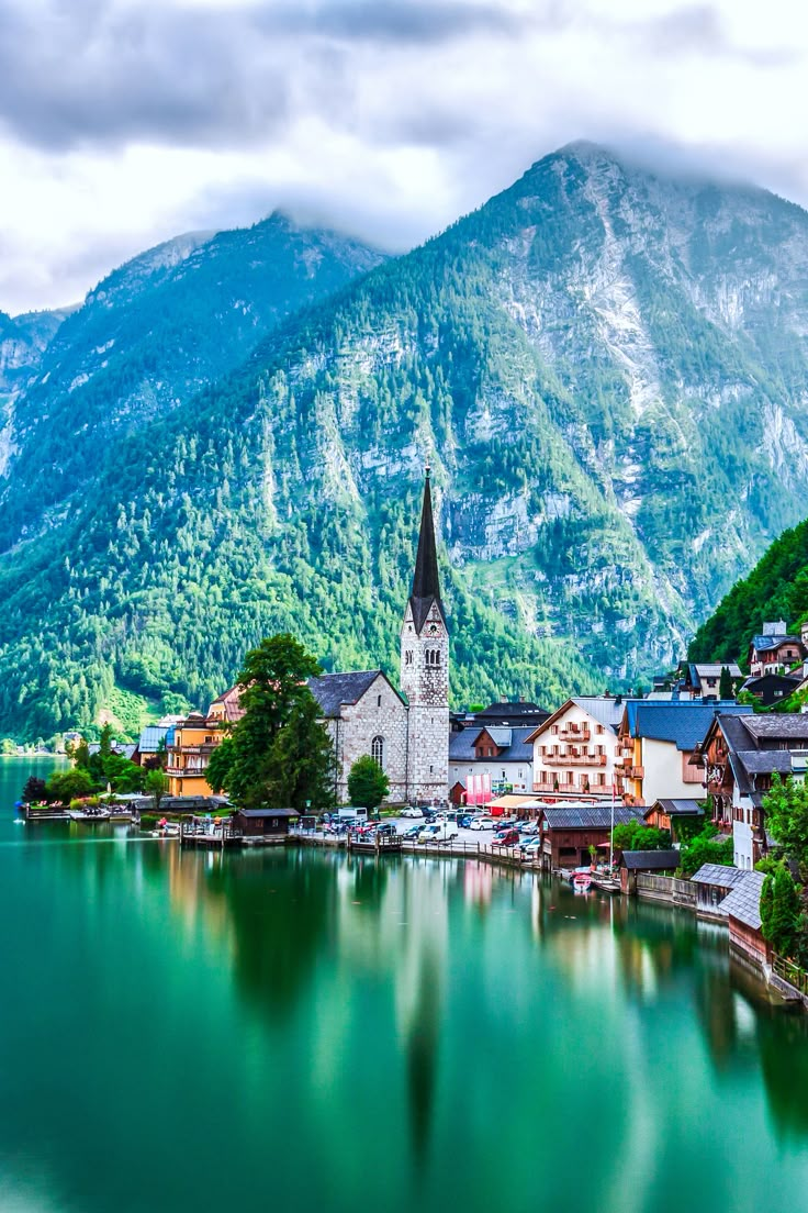 a lake surrounded by mountains with houses on it