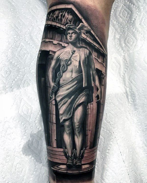 a man's leg with a statue on it