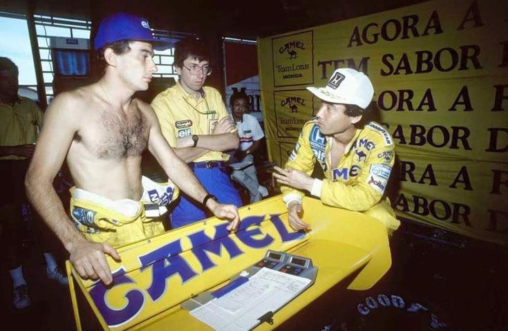 two men in yellow shirts and hats are talking to each other