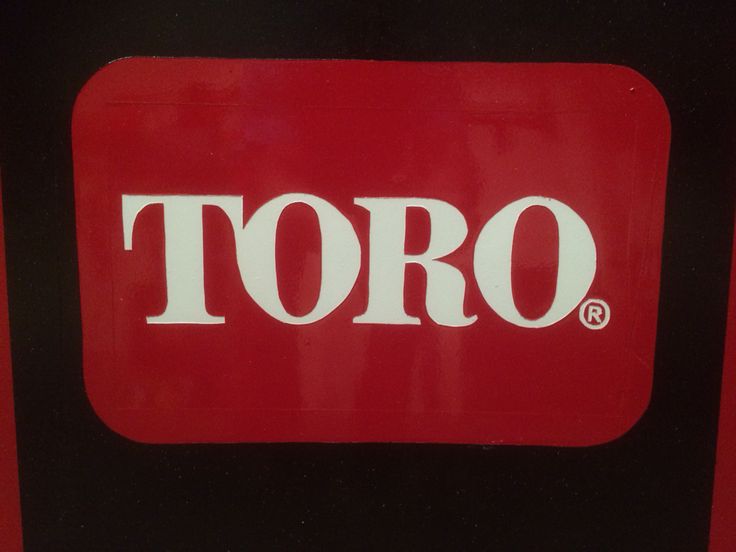 a red and black sign with the word toro on it