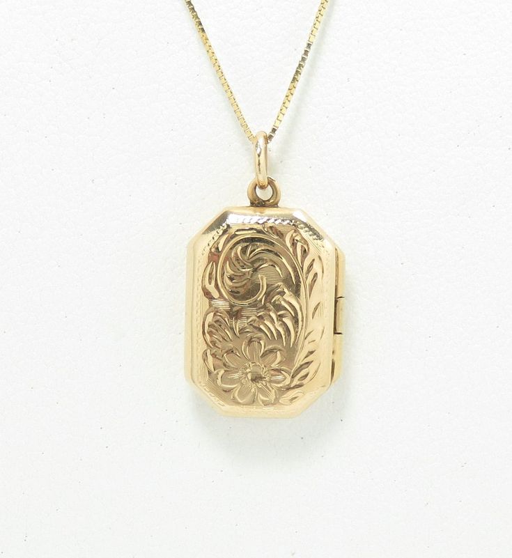 14k gold .5 x .75" condition: excellent Dainty and sweet antique locket, crafted of 14 karat yellow gold.  The locket is from the 1940s, and measures .5" wide and just under .75" high, not including the bail.  It has a rectangular shape, and is embellished with repousse period details on the front cover of the locket.  This locket is so lovely! The locket is in excellent condition inside and out.  It is marked 14k and is guaranteed to be 14k gold.  Please note that this listing is for the locket Vintage Gold Locket, Locket Vintage, Vintage Locket, Antique Locket, Locket Pendant Necklace, Vintage Lockets, Gold Locket, Locket Necklace, Locket