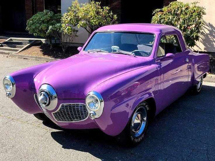 a purple car parked in front of a building