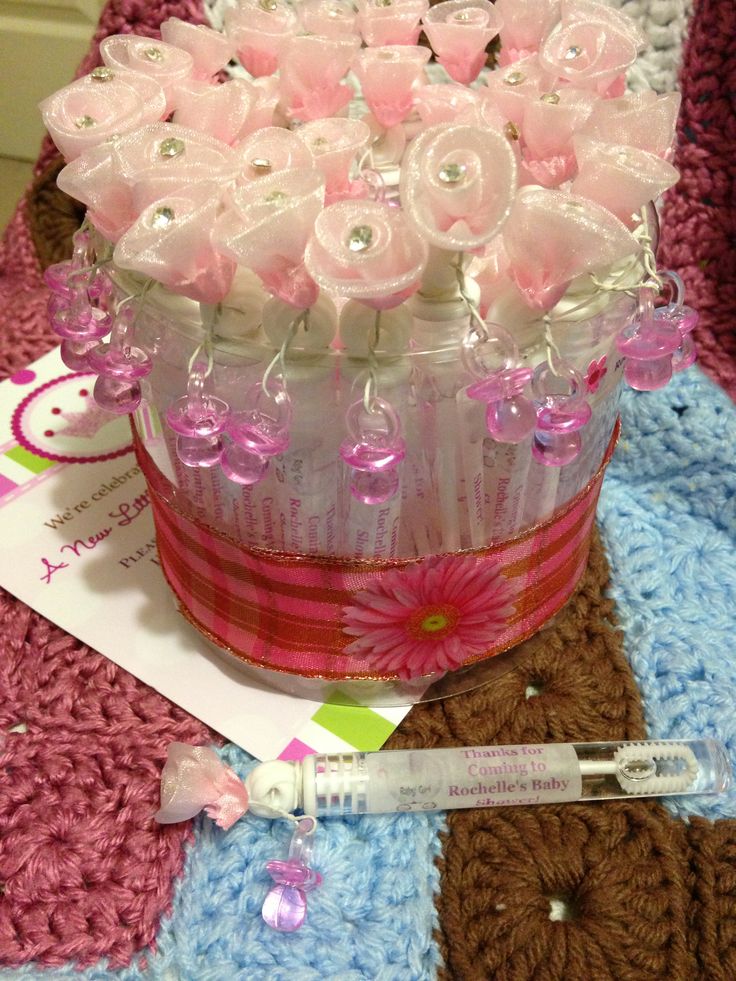 a crocheted pink and white basket with flowers in it