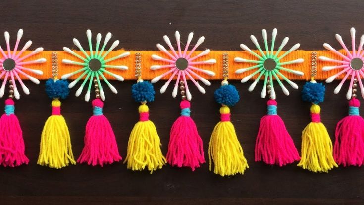 the colorful tassels are hanging on the wall