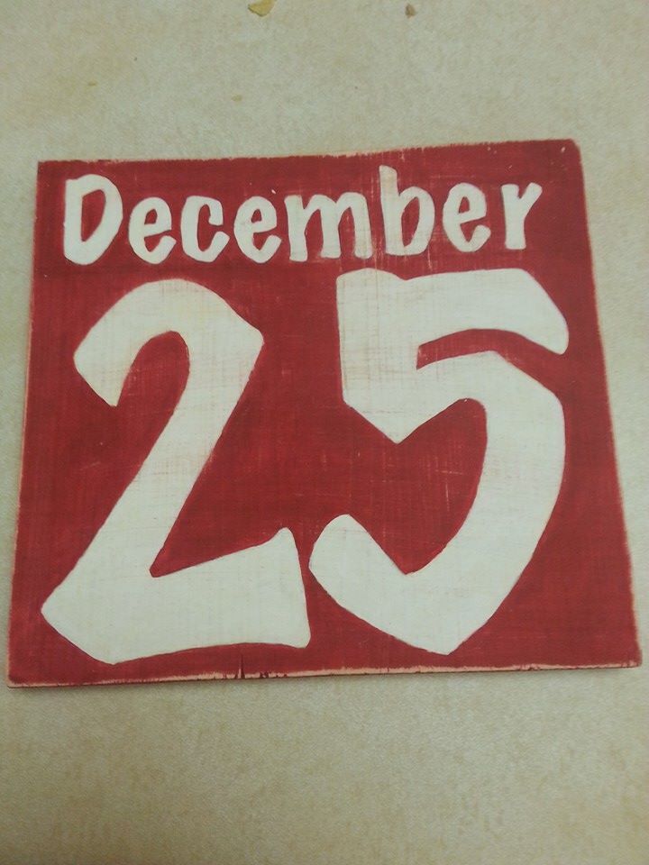 a red and white sign with the number twenty five on it that says december 25