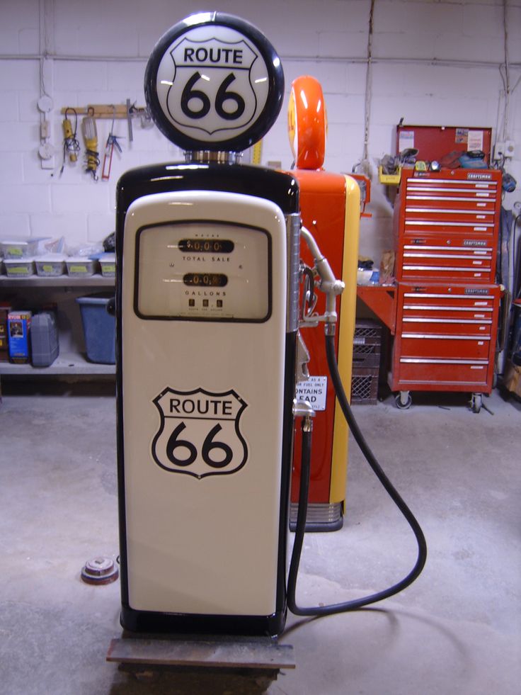 an old fashioned gas pump with route 66 on it's side in a garage