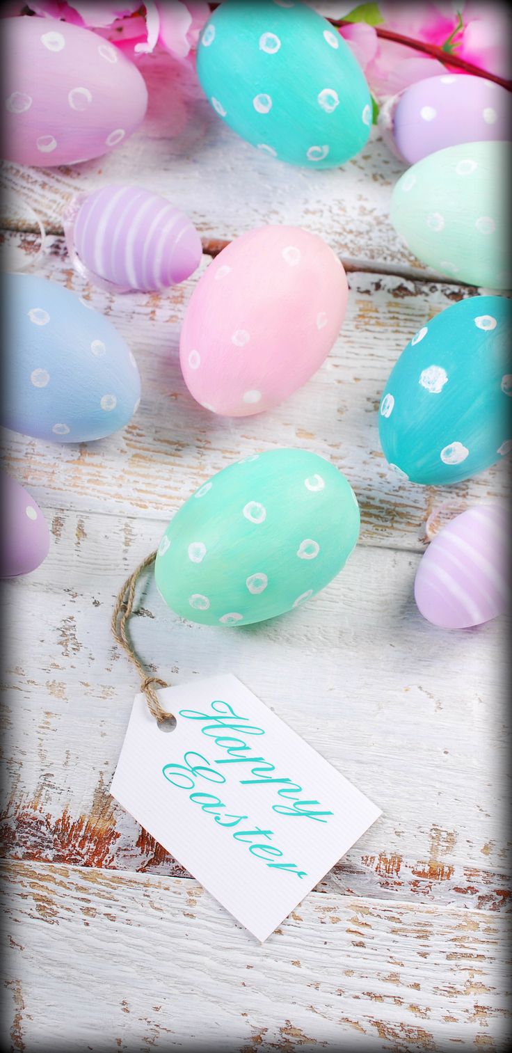 an image of colorful easter eggs on the ground with happy easter tag in foreground