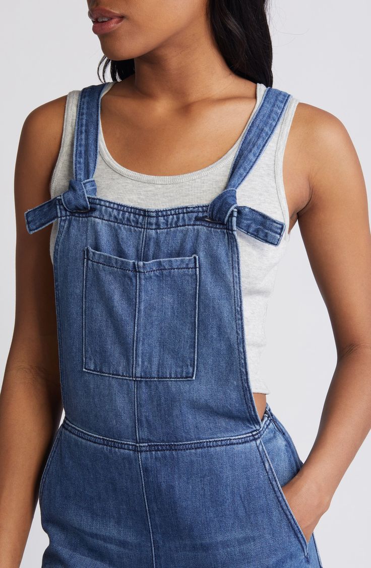 Raw hems and light fading give lived-in appeal to these laid-back overalls cut with a relaxed, straight-leg fit. 29" inseam Square neck Adjustable buckle straps 73% cotton, 27% rayon Machine wash, tumble dry Imported Medium Wash Relaxed Fit Denim Jumpsuit With Bib Front, Casual Straight Leg Light Wash Overalls, Casual Cotton Shortalls With Straight Leg, Casual Denim Straight Leg Shortalls, Casual Blue Shortalls With Adjustable Straps, Casual Medium Wash Denim Jumpsuit With Bib Front, Medium Wash Straight Leg Shortalls In Casual Style, Medium Wash Straight Leg Shortalls Casual, Casual Bib Front Denim Blue Jeans