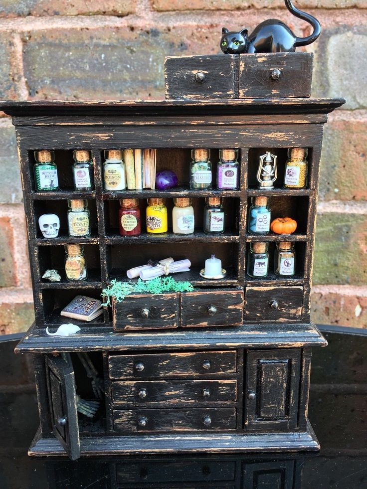 an old wooden cabinet with many bottles and spices on it's shelf next to a brick wall