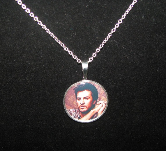 a necklace with a picture of a man on it